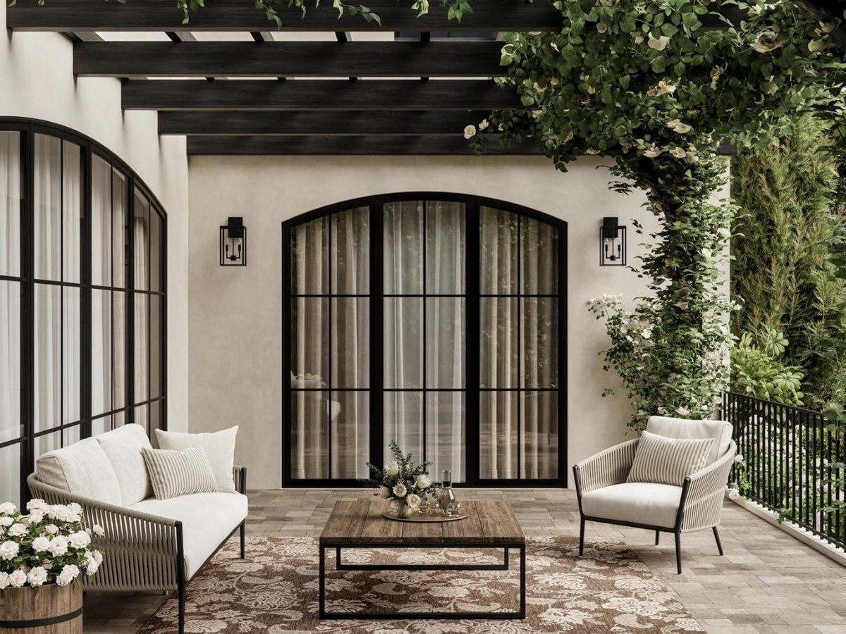Covered patio with arched steel doors, a vine-draped pergola and outdoor seating